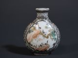 a small vase with a picture on it on a black background
