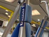 a person cleaning a bike with a blue sponge