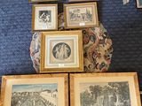 many framed pictures on the floor of this room