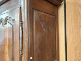 a large wooden armoire with a mirror on top of it