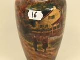a vase with a painting of a farm scene on it