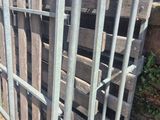 several wooden pallets are stacked on top of each other in a fenced in area