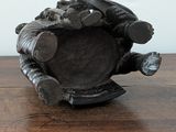 a wooden table with a metal object on it