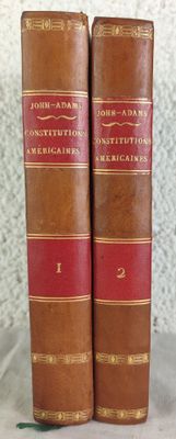 two old books sitting on top of a table next to each other