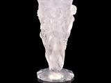 a glass vase that is sitting on a black surface