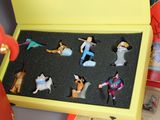 a yellow box with a bunch of figurines in it