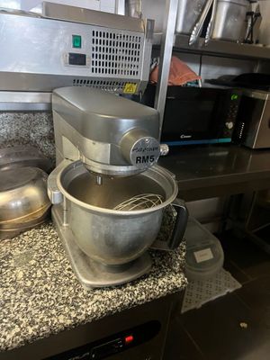 a kitchen counter with a mixer and a bowl on it