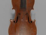 an old violin with a bow on a gray background