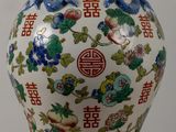 a vase with a floral design on it sitting on a table