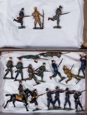 many figurines of soldiers in a cardboard box