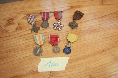 a lot of medals on a table with a note attached to it