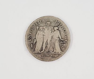 a close up of a coin on a white surface with a white background