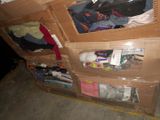 a cardboard box with clothes and other items in it