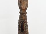 a wooden sculpture of a hand with a hole in the middle of it