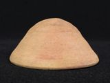 a small wooden cone on a black surface