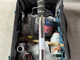 a bag filled with tools and other items on a table