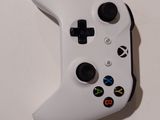 a close up of a white controller on a table