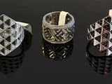 three different rings are shown on a table with a black background