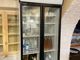 a refrigerator that has two bottles of beer in it