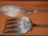 two forks and a spoon in a box on a table