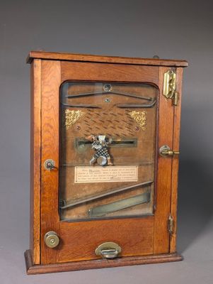 an old wooden clock with a glass case on the front of it
