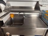a stainless steel sink in the middle of a kitchen