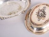 a silver plate and a silver bowl on a table