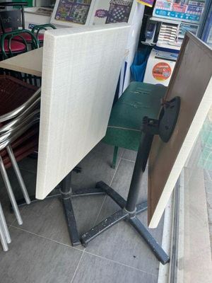 a table and chairs that are outside of a store