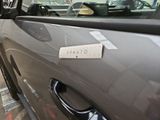 a close up of a car door handle with a sticker on it