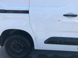 a white van parked in a parking lot next to a building