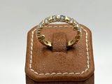 a close up of a ring on top of a wooden box