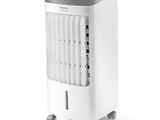 a white air cooler sitting on top of a white table