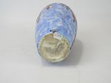a blue and white vase that has a hole in it