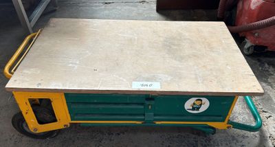 a green and yellow cart with a wooden table on it