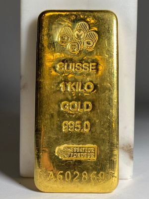un lingot d'or posé sur un bloc de marbre