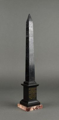 the obel is made of black granite and has a wooden base