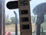 a close up of a vehicle ' s dashboard with a warning sign on it