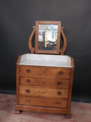 a small dresser with a mirror on top of it