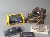 four different models of cars in boxes on a table