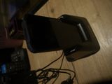a cell phone that is connected to a charger on a table