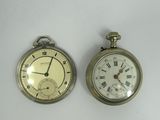 two clocks that are sitting side by side on a table