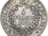 a silver coin with a wreath of flowers on it