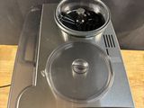 a coffee maker sitting on top of a wooden table