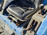 a blue truck with a black seat sitting in the back