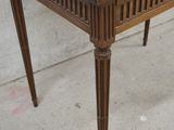a small wooden table with a drawer on top of it