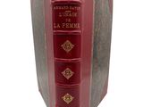 an old red book with gold trimmings on the cover