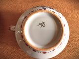 a close up view of a cup and saucer on a table