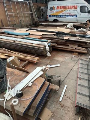 a truck that is parked next to a pile of wood