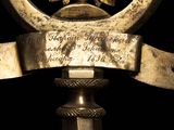 an image of a clock with a ribbon around it