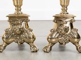 pair of antique brass candlesticks with lion heads and feet